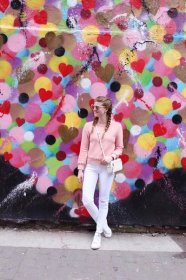 Lifestyle blogger Mollie Sheperdson shares a fun spring look in front of the Heart Wall in NYC