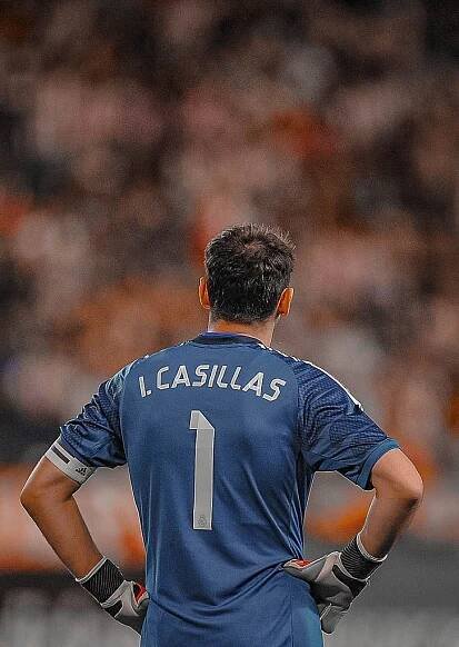 a soccer player with his back to the camera