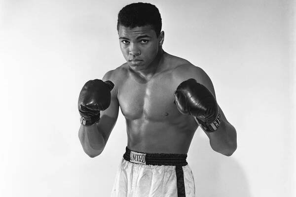 Cassius Clay in 1962 posing with boxing gloves.