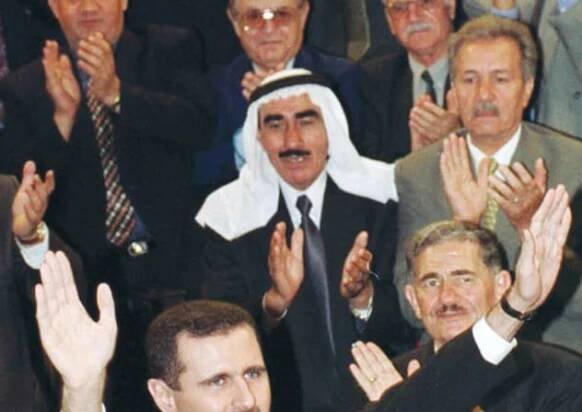 THEN-SYRIAN PRESIDENT Bashar al-Assad is cheered by deputies on his arrival in parliament, July 2000. He was formally sworn in after taking the office his late father, Hafez, had held for the previous three decades. 