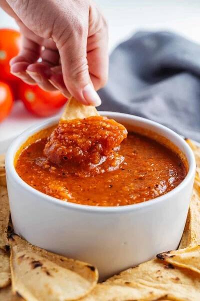Chip Dipped in a Bowl of Salsa Roja.