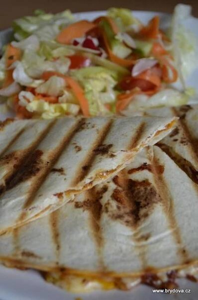 three quesadillas on a plate with coleslaw and lettuce