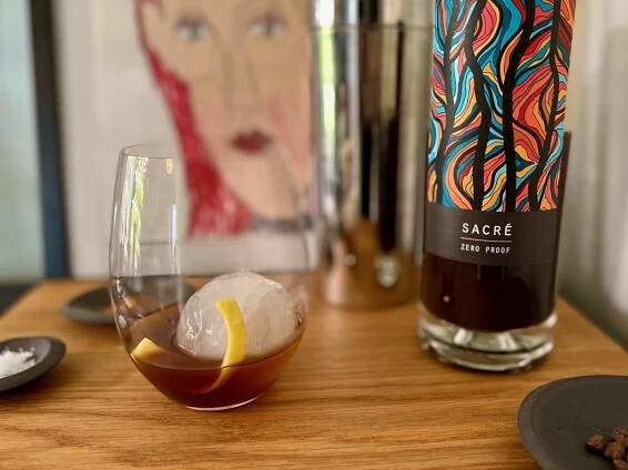 non alcoholic amaro substitute with lemon peel on ice with bottle