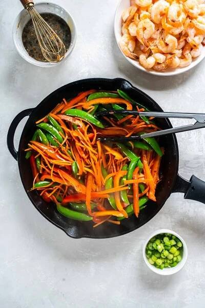 This easy Shrimp Stir Fry recipe has succulent shrimp and vegetables in a tangy, garlicky stir fry sauce. It's one of our favorite healthy recipes for a quick lunch or dinner!