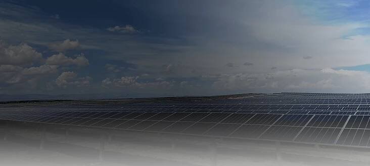 Solar installation with trackers and blue sky with clouds in background