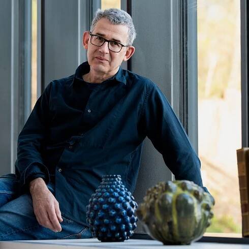 Edmund de Waal surrounded by Axel Salto’s work at CLAY Museum of Ceramic Art Denmark. Photo by Peter Leth-Larsen © Axel Salto/VISDA