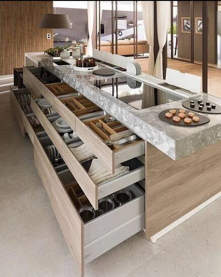 an open drawer in the middle of a kitchen