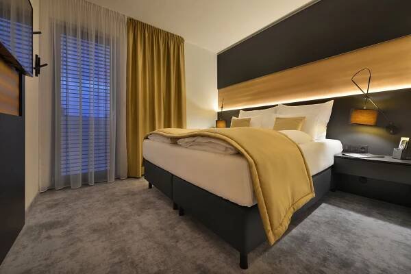 Postel nebo postele na pokoji v ubytování PREMIUM Wellness & Wine Hotel Znojmo