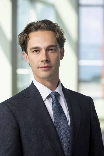 young male corporate attorney in high rise office 