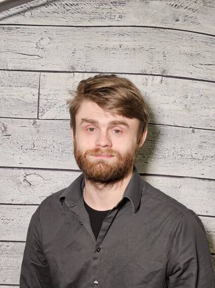 Bryan Tiderman headshot with wood panel background