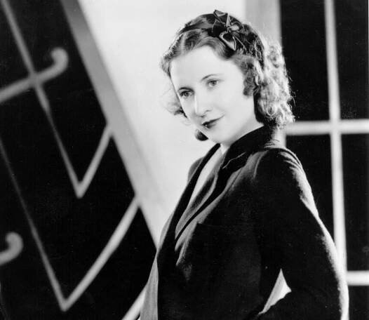 Barbara Stanwyck red-haired American actress in black top