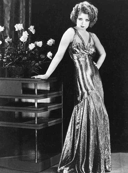 Silent screen siren Clara Bow (1905 - 1965) popularly known as the 'It' girl, wears a silver lame dress for the Paramount film 'No Limit', directed by Frank Tuttle.