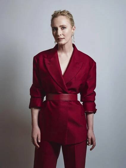a portrait of actor Genevieve O’Reilly in a red suit