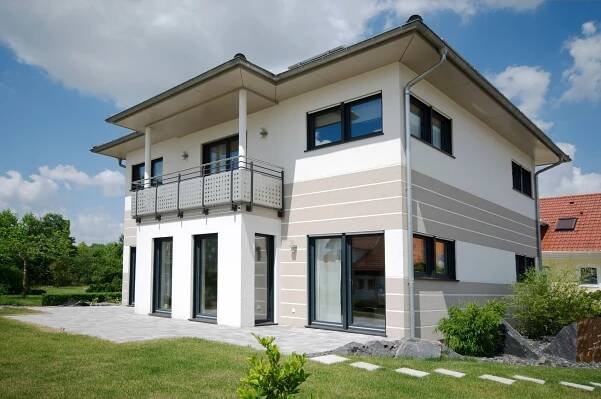a two story house with balconies on the second floor
