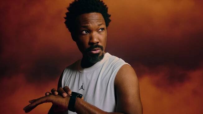 Corey Hawkins portrait with watch looking off camera.