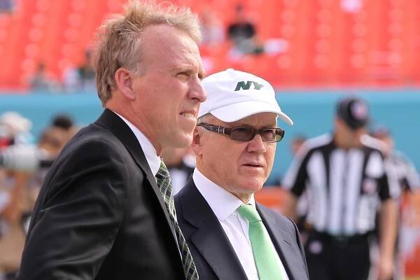 Woody Johnson, right, talking to John Idzik before the Jets beat the Dolphins, must explain the fate of his GM and coach, Rex Ryan, publicly.