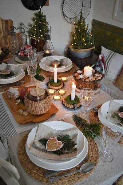 the table is set for christmas dinner with candles