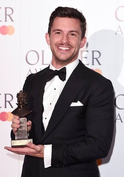 Jonathan Bailey holding the Best Actor In a Supporting Role in a Musical award for "Company" at the The Olivier Awards