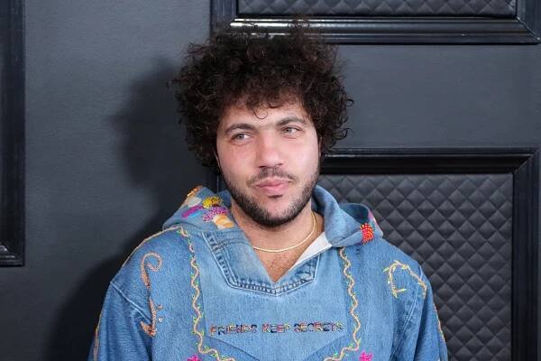 Benny Blanco wearing a denim hoodie with "Friends Keep Secrets" embroidery