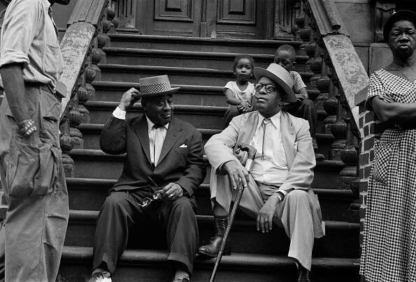 Luckey Roberts and Willie Smith sitting on a stoop.