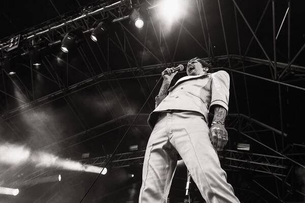 Justin Hawkins Of The Darkness performing on stage.