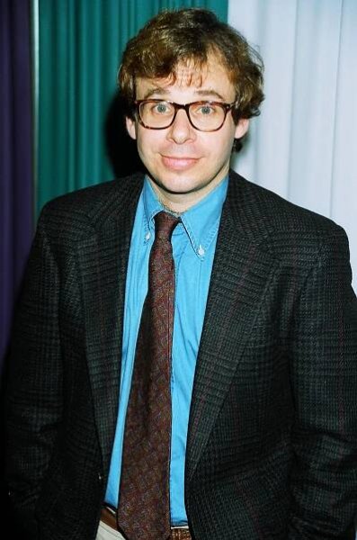 Image may contain Rick Moranis Accessories Formal Wear Tie Blazer Clothing Coat Jacket Necktie Suit Face and Head