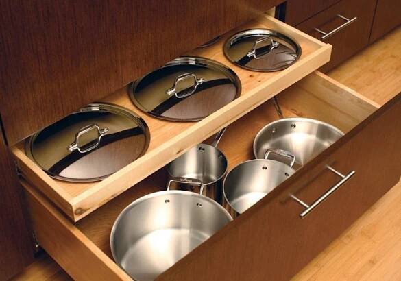 pots and pans are stored in the drawer