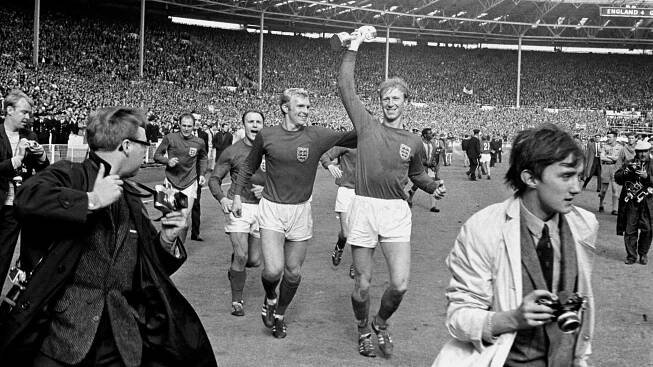 Jack Charlton (R) holds the Jules Rimet trophy aloft after England's 1966 World Cup win at Wembley