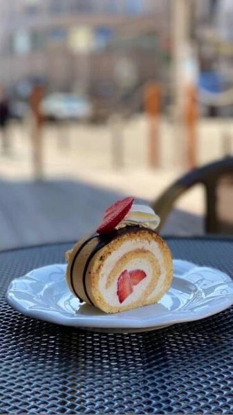 a plate that has some kind of pastry on it with strawberries in the middle