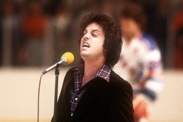 NEW YORK, NY - 1970'S:  Musician Billy Joel sings the National Anthem prior to an NHL game with the New York Rangers circa 1970's at the Madison Square Garden in New York, New York.  (Photo by Bruce Bennett Studios via Getty Images Studios/Getty Images)