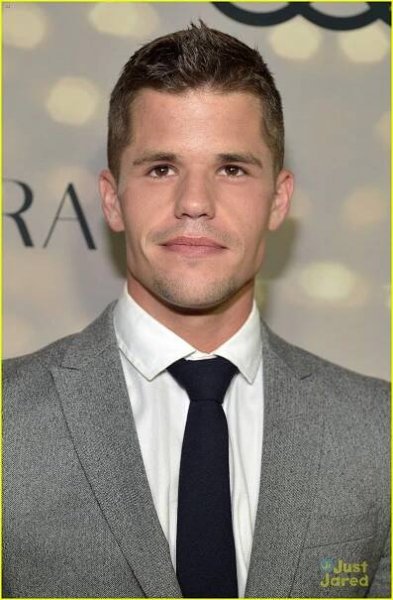 a man in a suit and tie posing for the camera