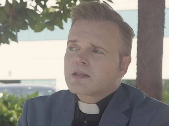 Still image of Rev. Dr. Jason Cook speaking with TRNN in front of the federal immigration courthouse in Santa Ana, CA, on July 14, 2025. Still image from TRNN documentary report 