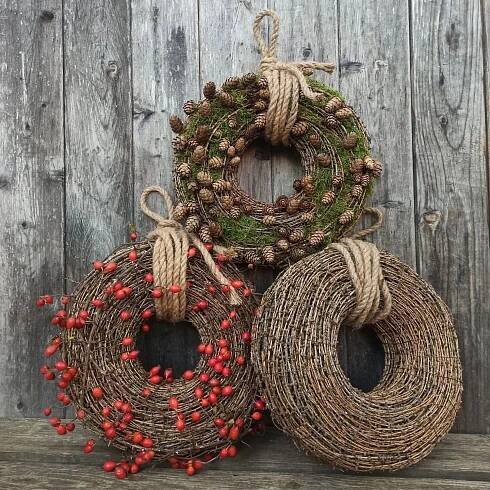 three twine wreaths with red berries on them