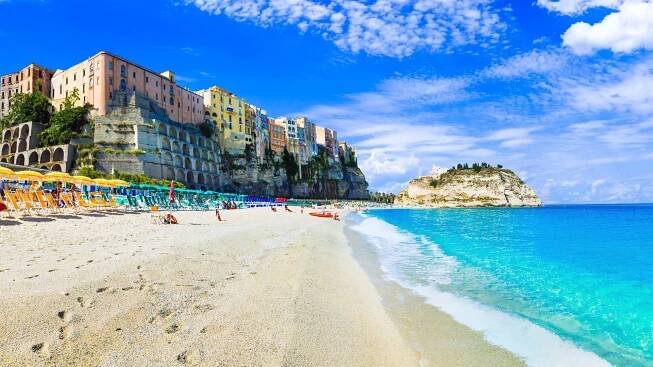 A quiet beach with sun loungers and umbrellas in Tropea