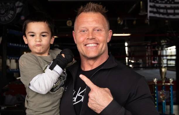 Todd Smith posing with a young boxer at South Boxing gym