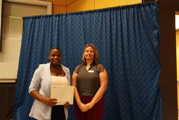 Student receiving award from Jennifer Freeman. ${altNumber}