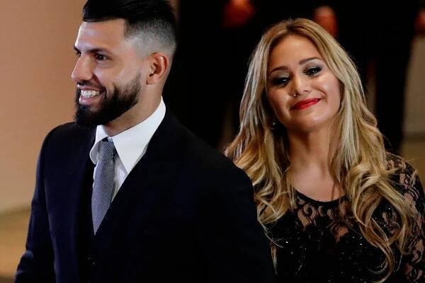Manchester City striker Sergio Aguero and his girlfriend Karina Tejeda smile as they arrive to attend the wedding of Lionel Messi and Antonella Roccuzzo, in Rosario, Argentina, Friday, June 30, 2017. Some 260 guests, including teammates and former teammates of the Barcelona soccer star are attending the highly anticipated ceremony. (AP Photo/Victor R. Caivano)