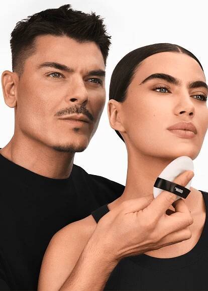 makeup by mario posing with model wearing new setting powder