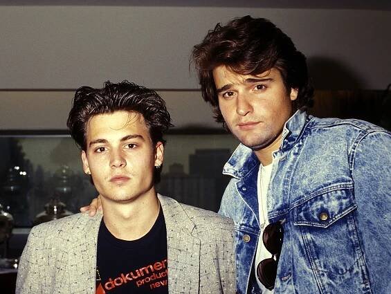 Johnny Depp and Peter DeLuise pose during a media event.