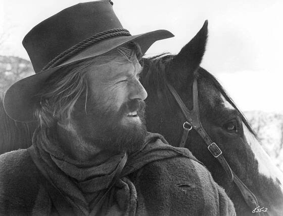 Robert Redford Standing With A Horse In A Scene From 'Jeremiah Johnson', 1972.