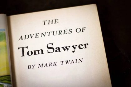 "The Adventures of Tom Sawyer by Mark Twain" against a black background.