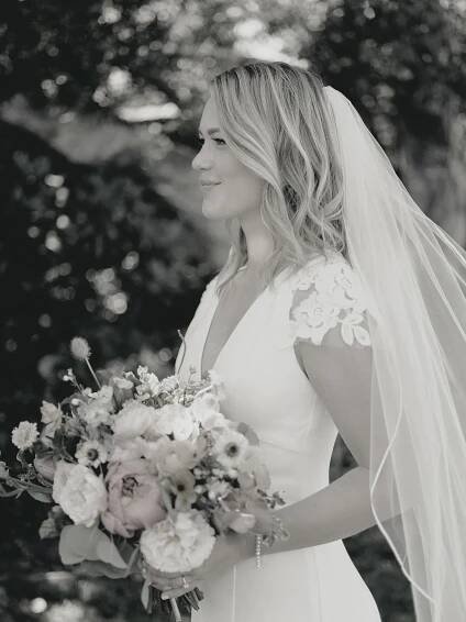 Classic black and white bridal portrait with a flowing bouquet at Thomas Forgarty Winery in Woodside.