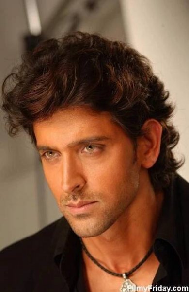 a close up of a person wearing a black shirt and a necklace on his neck