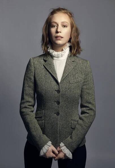Image may contain Clothing Apparel Human Person Sweater Cardigan Coat and Overcoat Hannah Einbinder