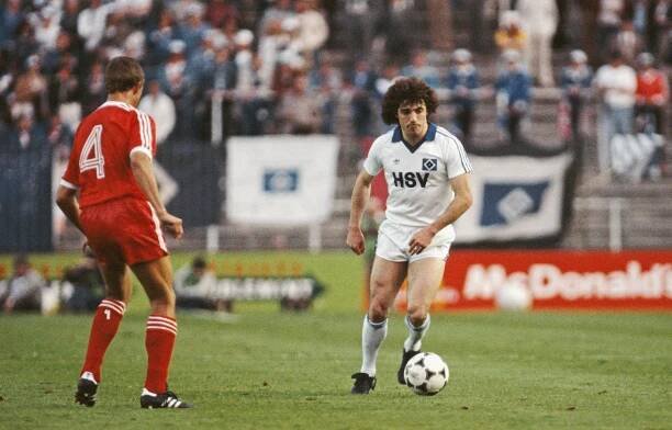 Kevin Keegan of Hamburg SV dribbling the soccer ball during a game.