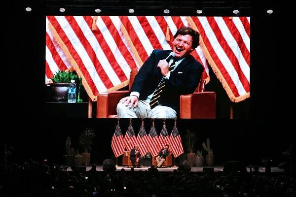 Former US President and Republican presidential candidate Donald Trump (L) speaks during a live interview with US commentator Tucker Carlson in the finale of the Tucker Carlson Live Tour at Desert Diamond Arena in Glendale, Arizona, on October 31, 2024. (Photo by Patrick T. Fallon / AFP) (Photo by PATRICK T. FALLON/AFP via Getty Images)