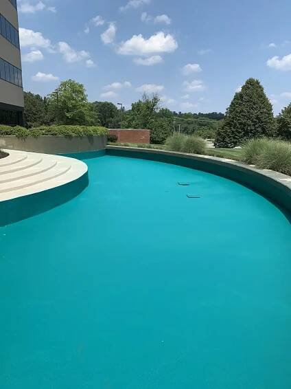 Photo of a fountain basin coated in Rub-R-Wall waterproofing coating to prevent water from seeping into the concrete