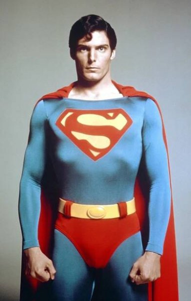 a man in a superman costume with the letter s on his chest