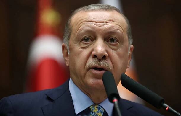 Turkish President Tayyip Erdogan addresses members of parliament from his ruling AK Party during a meeting at the Turkish parliament in Ankara
