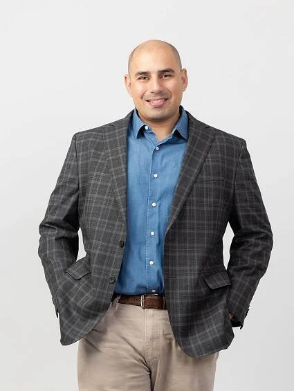 Business professional in plaid blazer and blue shirt standing confidently against white backdrop. Temecula - Murrieta - Menifee - Corona Pho